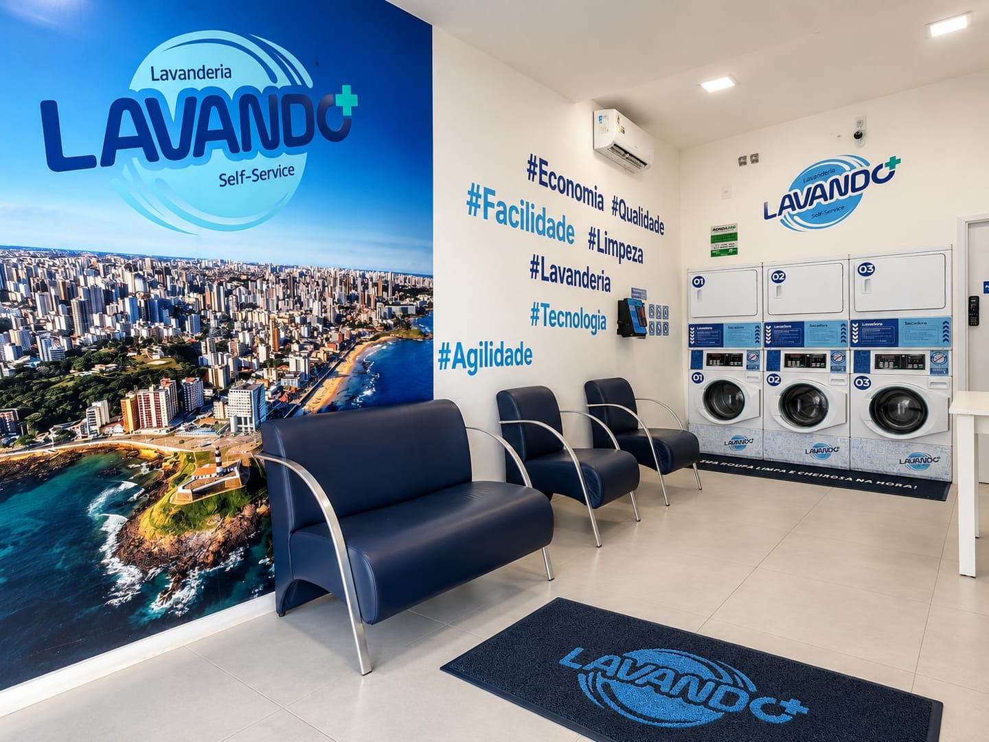 Waiting lounge with navy armchairs, a wall of hashtags, air conditioning, the payment kiosk on the wall and the washers and dryers in the back